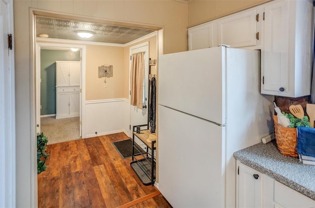 kitchen featuring white cabinetry, white fridge, and dark wood-type flooring