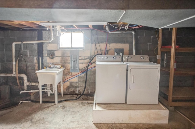 clothes washing area with sink and washer and dryer