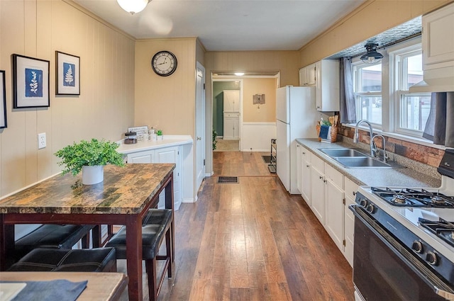 kitchen with white cabinets, dark hardwood / wood-style flooring, and range with gas stovetop