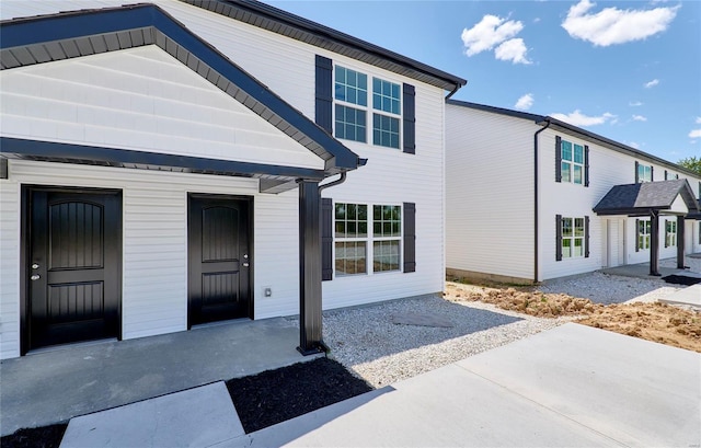 rear view of property featuring a patio area