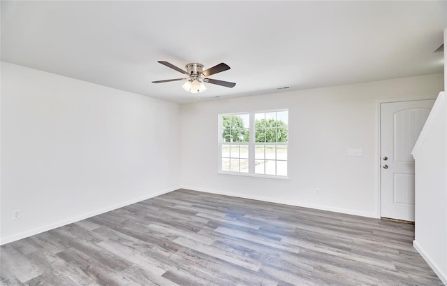 spare room featuring ceiling fan and light hardwood / wood-style floors