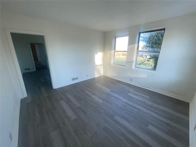 unfurnished room featuring dark hardwood / wood-style flooring