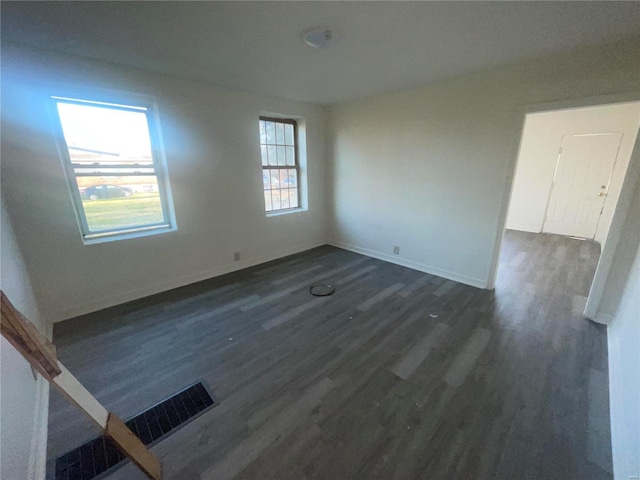 spare room featuring dark wood-type flooring