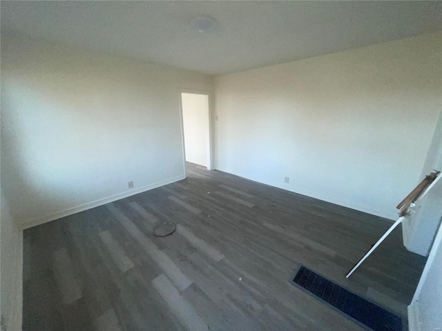 spare room featuring dark hardwood / wood-style floors