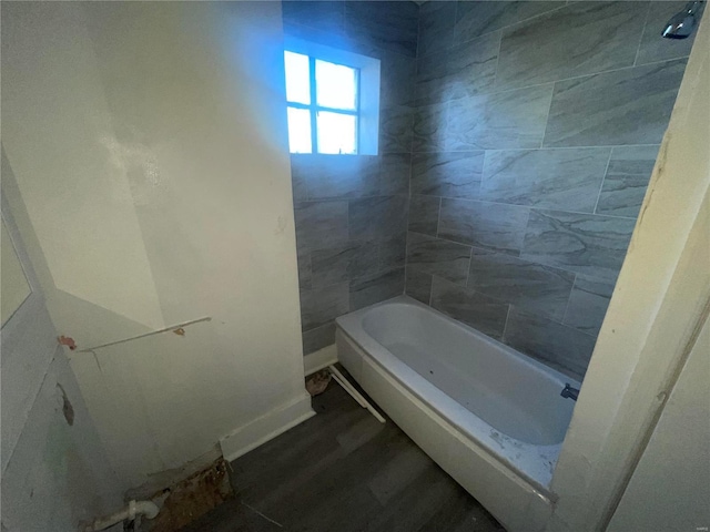 bathroom featuring hardwood / wood-style floors and tiled shower / bath