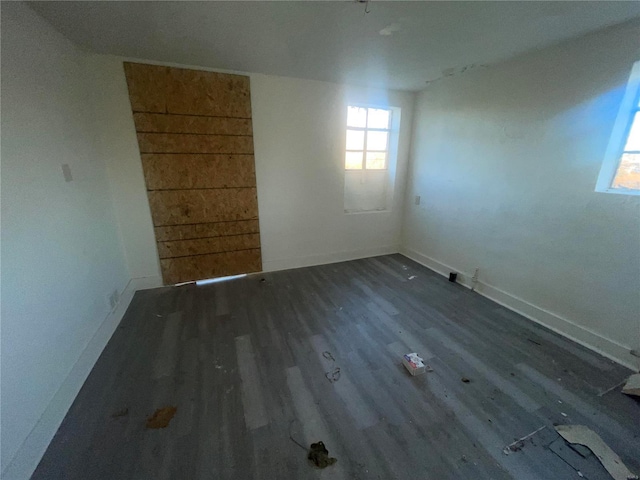 unfurnished room with dark hardwood / wood-style floors