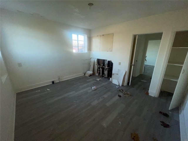 unfurnished bedroom with dark wood-type flooring