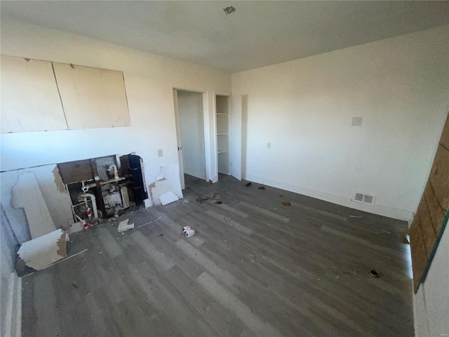 unfurnished living room featuring dark wood-type flooring