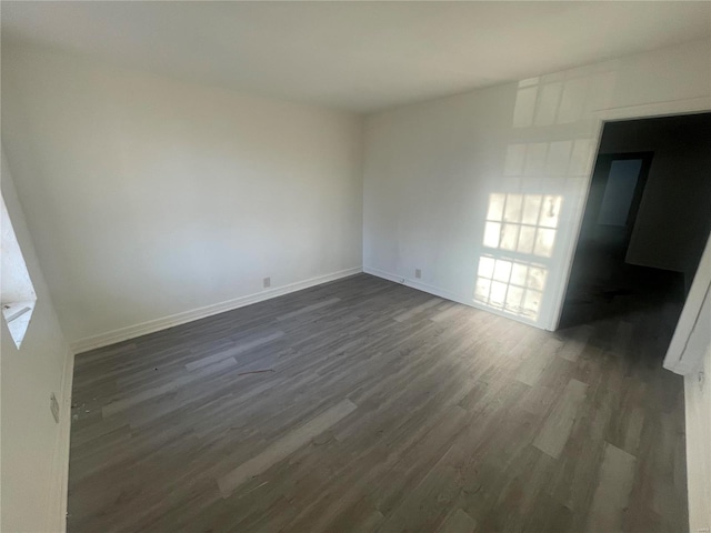 spare room with dark hardwood / wood-style floors