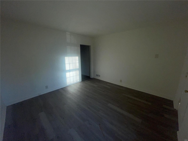 empty room with dark wood-type flooring