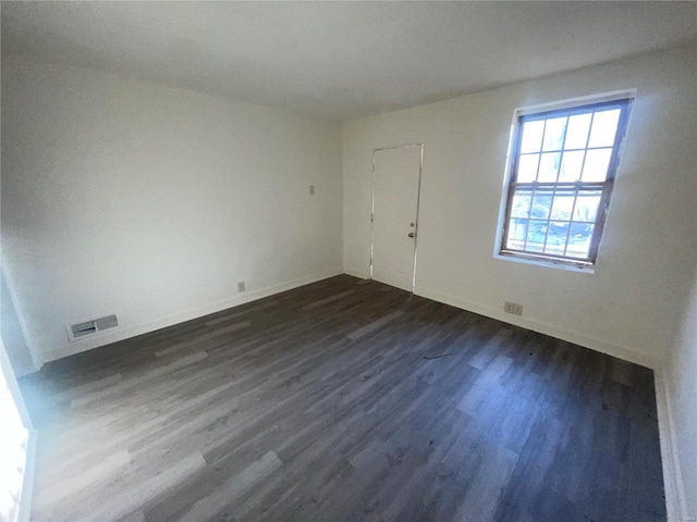 spare room with dark hardwood / wood-style floors