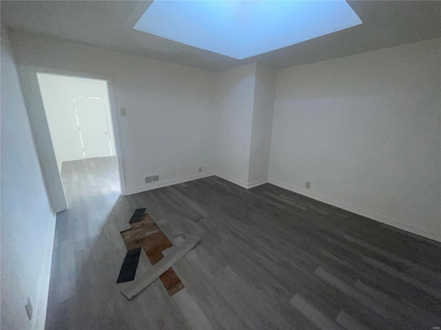 unfurnished room featuring dark wood-type flooring