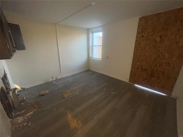 unfurnished room featuring dark hardwood / wood-style floors