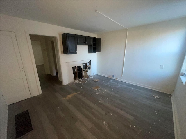 unfurnished living room featuring dark hardwood / wood-style floors