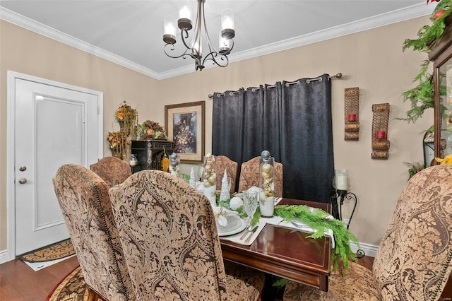 dining area with hardwood / wood-style flooring, a notable chandelier, and ornamental molding