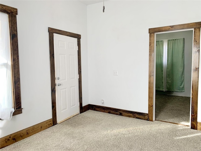 carpeted spare room with baseboards