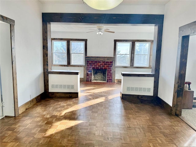 unfurnished living room featuring visible vents, baseboards, and a fireplace