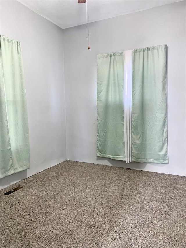 unfurnished room with carpet and visible vents