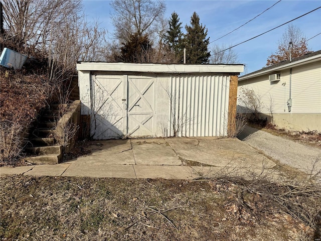 view of outdoor structure with an outbuilding and a wall mounted air conditioner