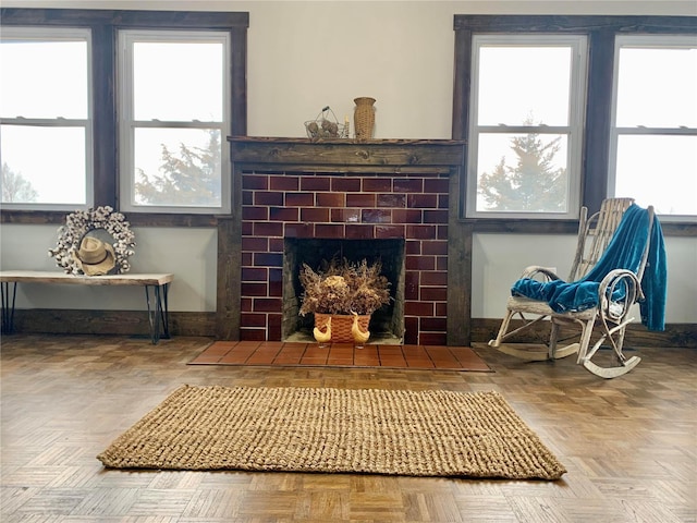 sitting room with a fireplace and baseboards