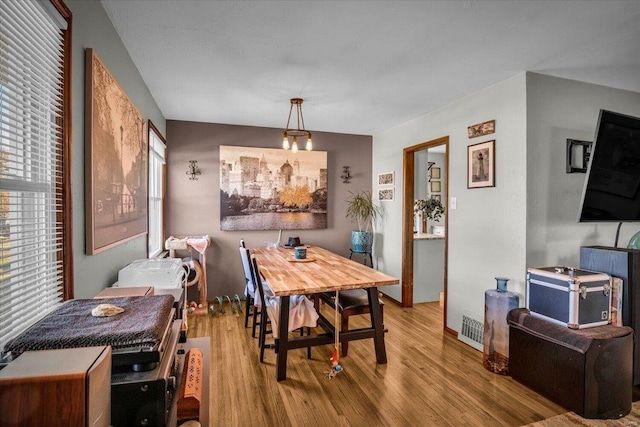 dining space featuring wood-type flooring