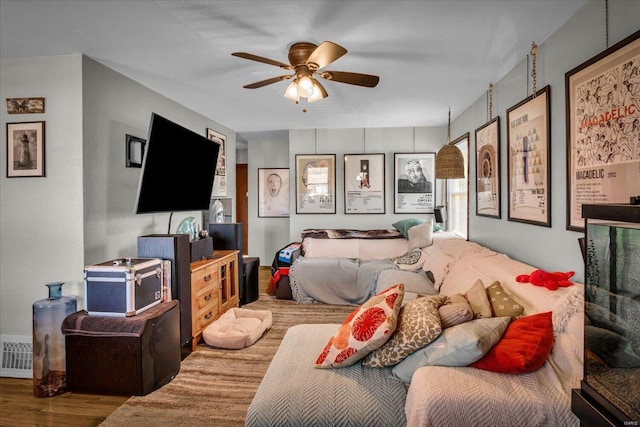 bedroom with ceiling fan and hardwood / wood-style floors