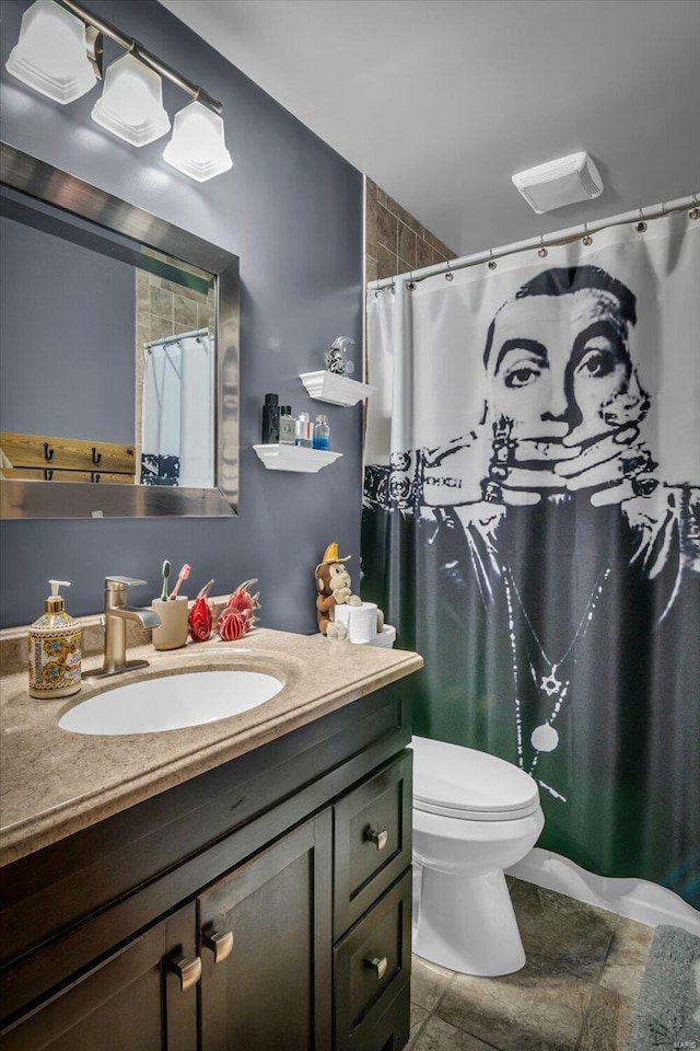 bathroom featuring vanity and toilet