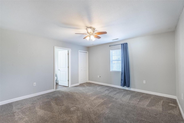 carpeted spare room with ceiling fan and a textured ceiling