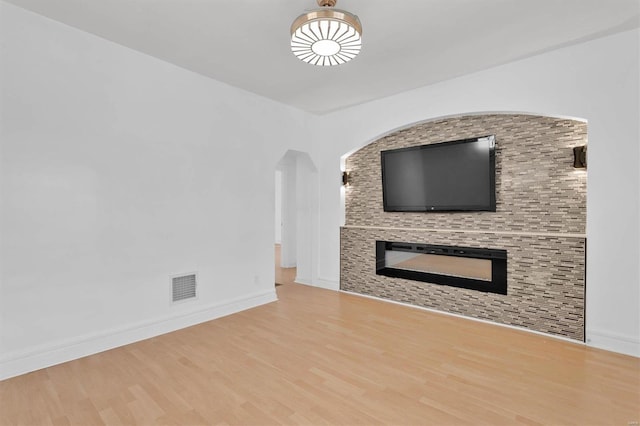 unfurnished living room featuring hardwood / wood-style flooring