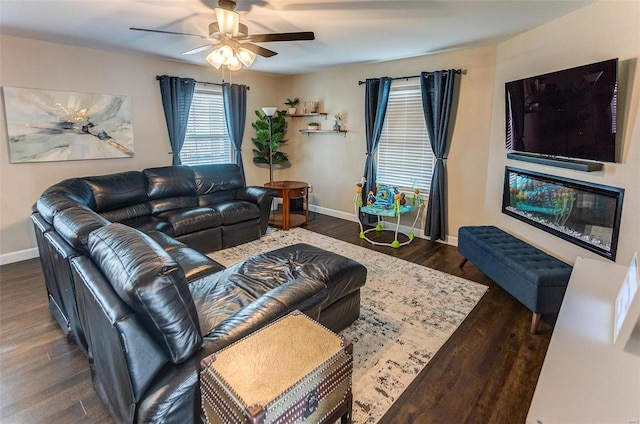 living room featuring ceiling fan and dark hardwood / wood-style floors