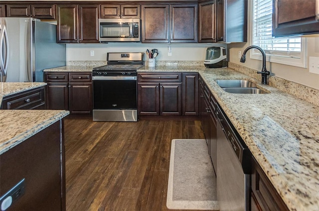 kitchen with dark brown cabinetry, sink, dark hardwood / wood-style flooring, and appliances with stainless steel finishes