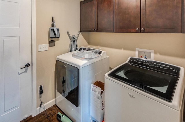 laundry room with cabinets, separate washer and dryer, and dark wood-type flooring