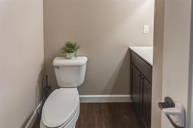 bathroom featuring vanity, hardwood / wood-style flooring, and toilet