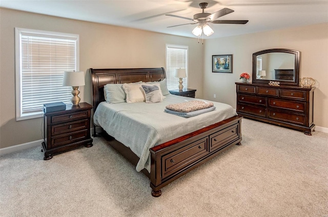 bedroom featuring light colored carpet and ceiling fan