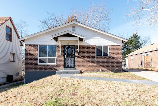 bungalow-style home with a front yard