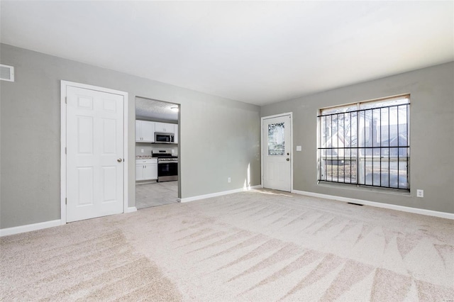 unfurnished living room with light carpet