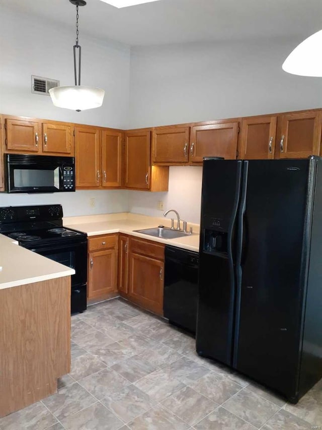 kitchen with black appliances, pendant lighting, sink, and high vaulted ceiling