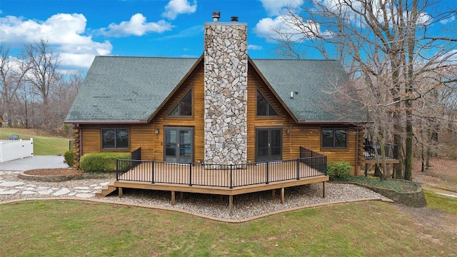 back of property featuring a deck and a yard