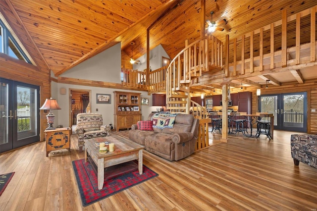 living room with french doors, light wood-type flooring, wood ceiling, ceiling fan, and high vaulted ceiling