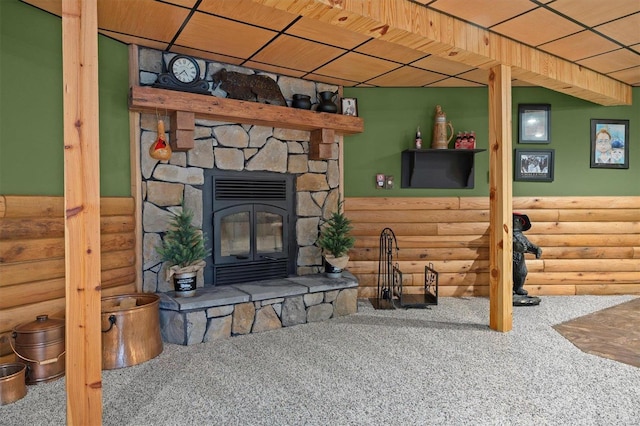 carpeted living room with wood ceiling and log walls