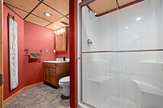 bathroom featuring vanity, toilet, and a shower with shower door