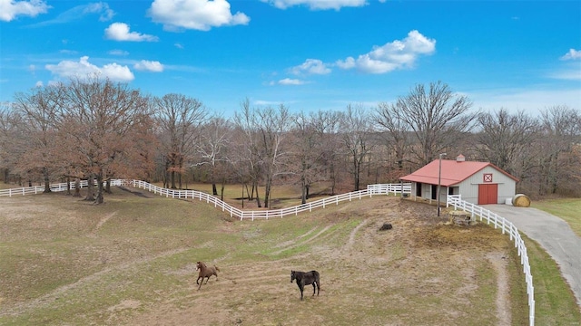 view of yard with a rural view and an outdoor structure