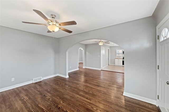 interior space with ceiling fan and dark hardwood / wood-style flooring