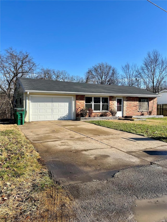 single story home featuring a front yard and a garage