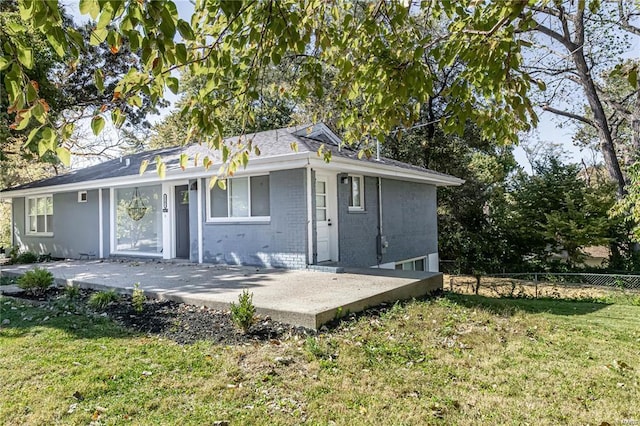 back of house with a patio area and a yard