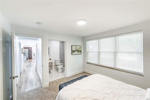 carpeted bedroom with ensuite bath