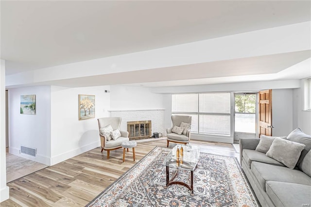 living room featuring a fireplace and light hardwood / wood-style floors