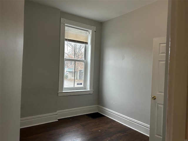 empty room featuring dark wood-type flooring