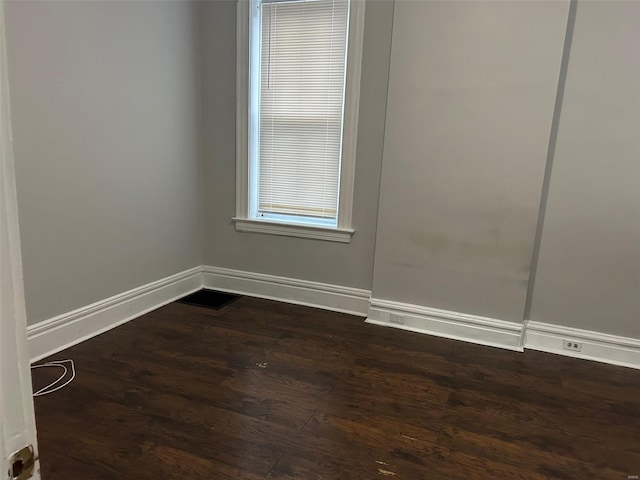 spare room featuring dark wood-type flooring