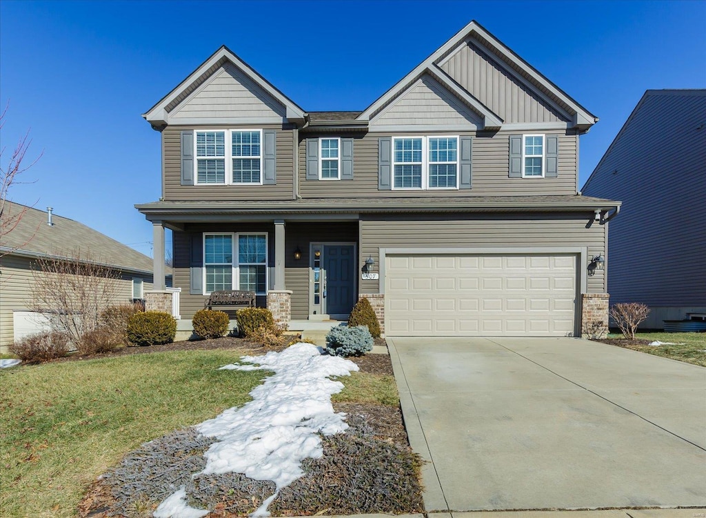 craftsman house with a garage and a front lawn